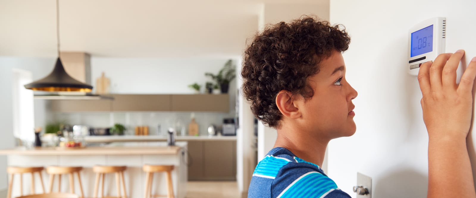 Boy changing the thermostat
